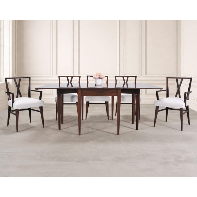 An iconic and rare set of eight mid-century modern dining chairs consisting of six side chairs and two host armchairs...