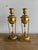 These candleholders are a pair of ornate classical style bronze pieces. They feature a design with a fluted top section...