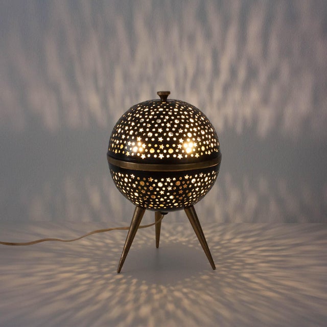 Delightful little mood table lamp from France, circa 1950. The pierced aluminum globe is covered in tiny circle and star...