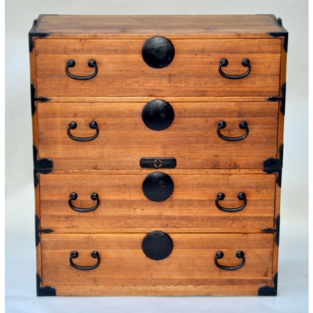 A Japanese two-piece Kasane Isho chest crafted from Kiri (Paulownia) and Sugi (Cryptomeria) woods, with original hand-...