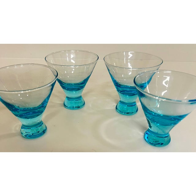 Set of four- Vintage, capri blue, stemless, handblown cocktail glasses are 3.75" tall. The rims are 3.5" across, and the...