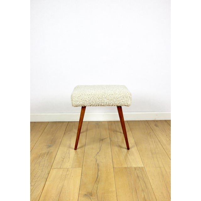 High stool seat with beige boucle upholstery and round beech legs. A vintage stool manufactured in the 1970s. Completely...