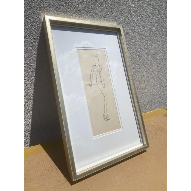 This is a framed vintage fashion illustration. This particular piece features the original mannequin form drawn in ink....