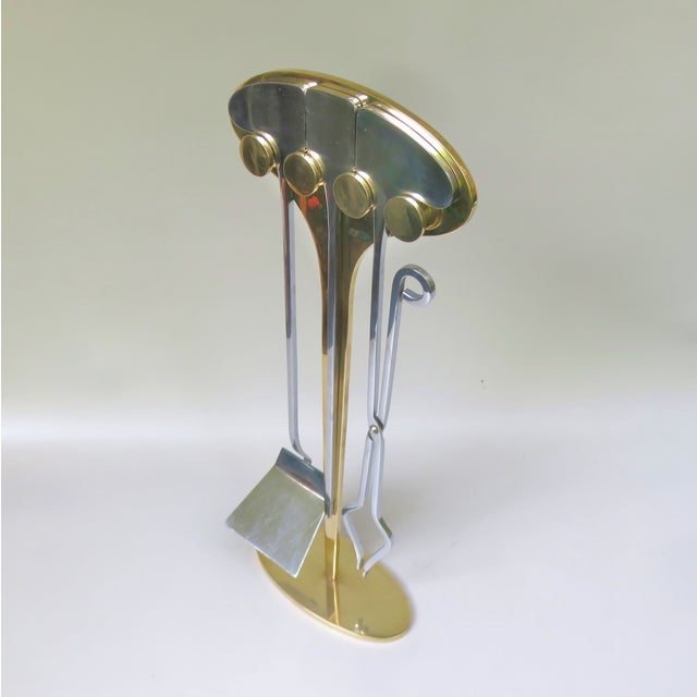 In the extraordinary and at the same time elegant fireplace cutlery with a shovel, pilot and pliers, made in the 1970s,...