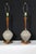 A pair of sculptural pair inspired by organic elegance of mid century design. Thesr ceramic and walnut lamps bring warmth...