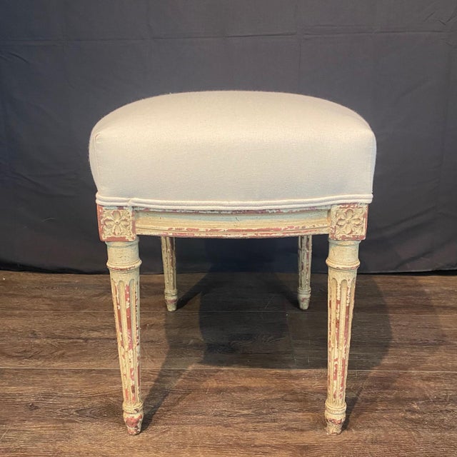 Classic 19th century French Louis XV style pair of cream painted walnut footstools or ottomans, newly upholstered in a...