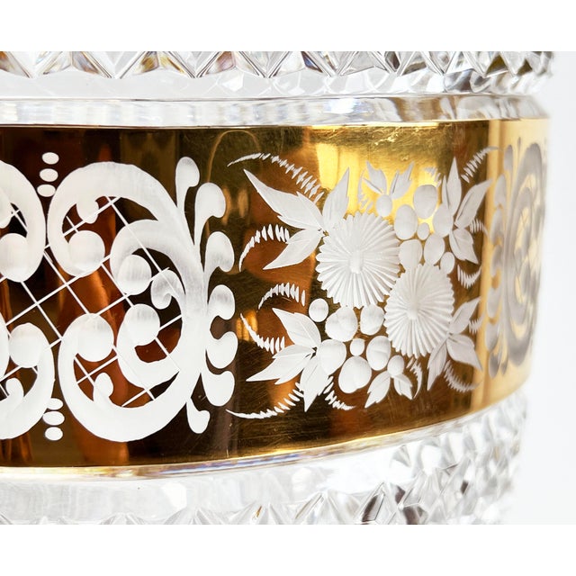 This brilliantly cut crystal vase from Bohemia features a striking wide gilt band etched with delicate florals and...