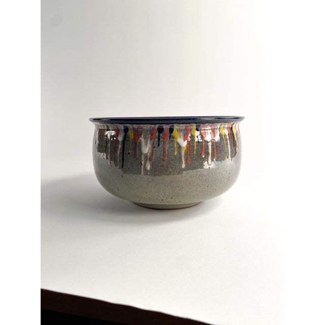 Beautiful multi colored drip glaze bowl with speckled glaze inside. signed by artist on underside.