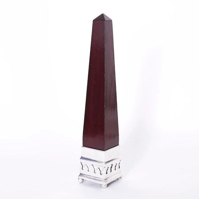 Standout pair of Anglo Indian obelisks with classic form crafted in mahogany and with silver plate bases with floral...