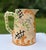 Charming vintage crackle finish ceramic pitcher, hand painted with flowers and scrolls in bright cheery colors. Pitcher is...