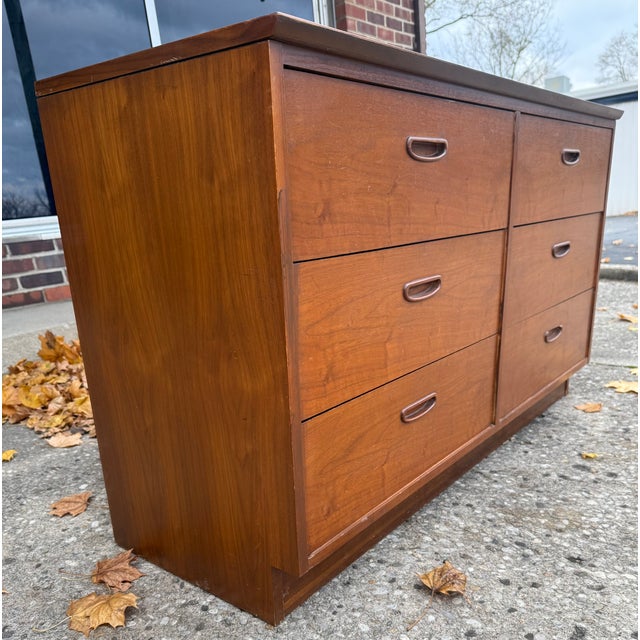 Mid-century modern 6-drawer low boy dresser by Lane Furniture, featuring a sleek plinth base and rich wood grain. Top is a...