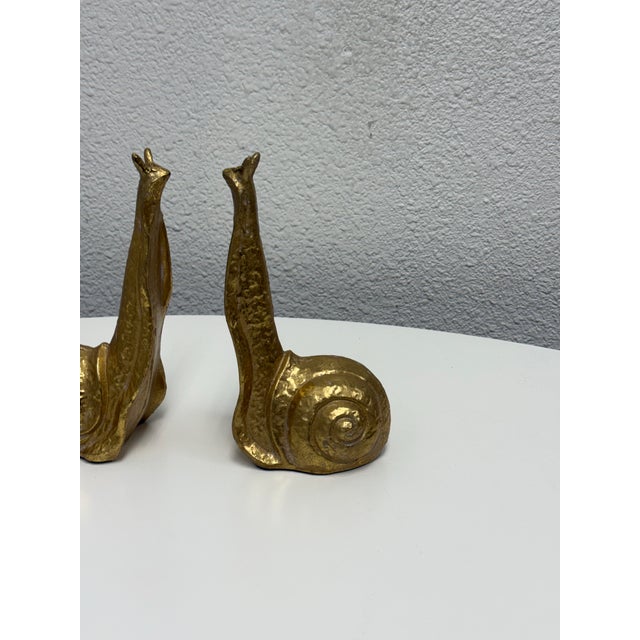 Design Plus Gallery presents a Pair of Gold Gilded Snail Bookends from Anthropologie. Whimsical yet sculptural, this pair...