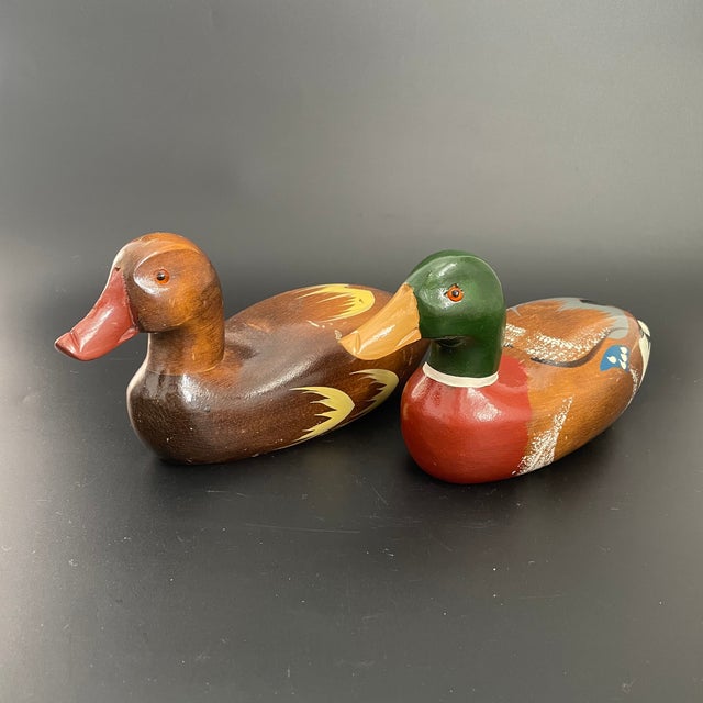 A vintage pair of mallard decoys, consisting of a drake and a hen. Hand carved and hand painted. Glass eyes. Nice...