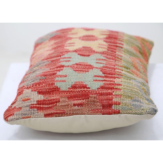 A one-of-a-kind handwoven Afghan wool kilim lumbar pillow featuring hooked-cross star lattice. Cut and sewn by hand from a...