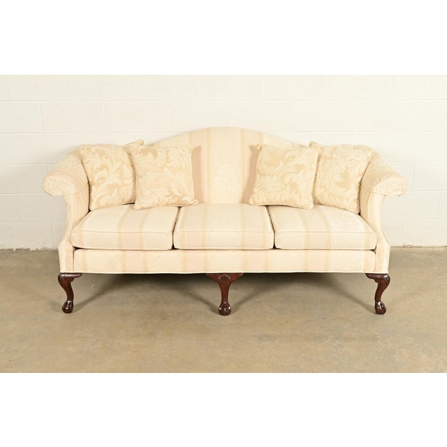 A gorgeous Chippendale or Georgian style camelback sofa By Ethan Allen USA, Circa Late 20th Century Mahogany, with carved...