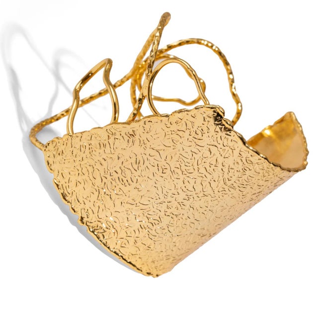 Ignite your style with the Golden Flame Arm & Cuff Bracelet. Handcrafted from bronze and plated with luminous 18k gold,...