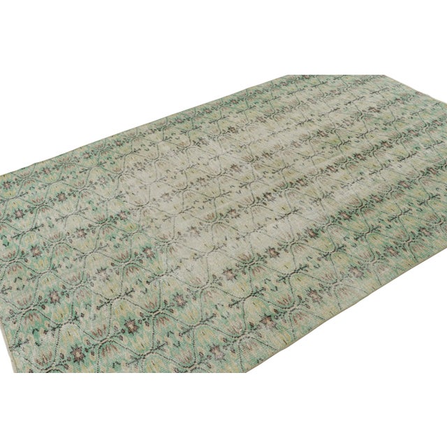 Hand Knotted in wool, this 6×9 vintage Zeki Múren rug originating from Turkey, circa 1960-1970, features geometric...