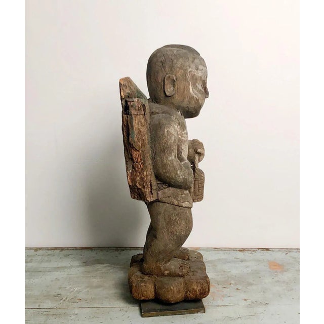 A late 19th / early 20th century fragmentary wood carving of a workman, circa 1900.