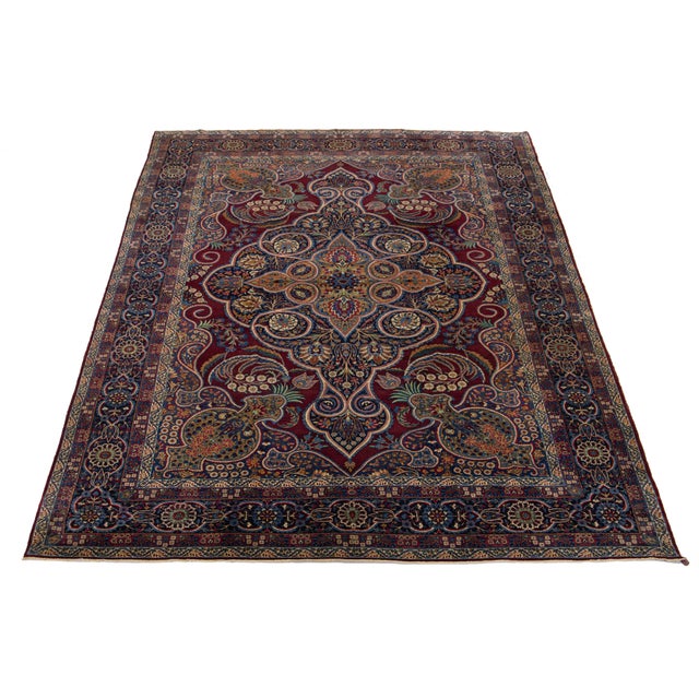 This hand-knotted wool rug is an exquisite antique from the 1900s. Its enchanting floral design in multiple colors...