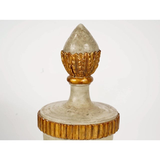 This is an unusual and outstanding pair of parcel gilt carved Urns. The urns are in excellent overall condition for their...