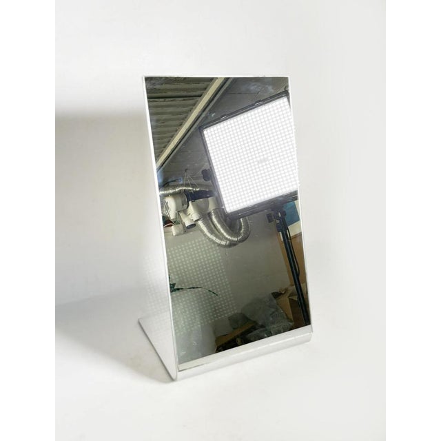 A simple and elegant table mirror, composed of an aluminum frame and a rectangular glass panel. Its slightly angled shape...