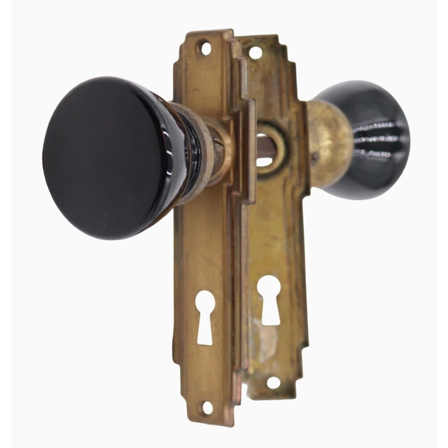 Vintage Art Deco style door knob set made with black glass knobs. The back plates are made of steel and brass. The...