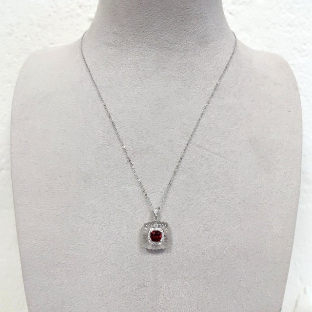 A luminous composition in platinum, this pendant centres on a vivid red spinel — a gemstone admired for its rich colour,...