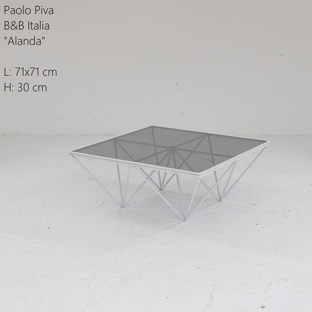 Lounge table in white lacquered metal with smoked glass, solid and stable, modern and very contemporary lines that...