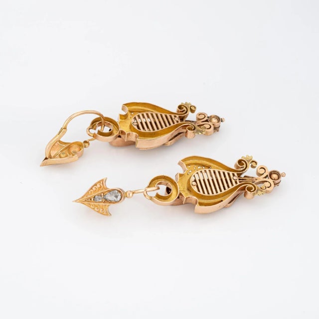 Elegant pair of antique Victorian earrings (circa 1860s to 1870s) crafted in 14k yellow gold. Old rose cut diamond range...