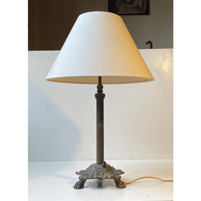 A fluted column table lamp with lion paws - everything executed in patinated brass and featuring its original bakelite...