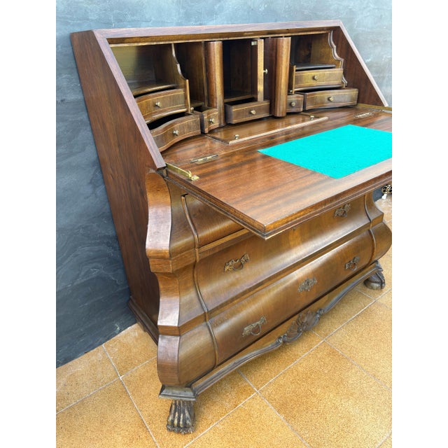 Elegant baroque style bureau desk featuring a distinctive bombe front and a drop-front writing surface. The interior...