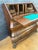 Elegant baroque style bureau desk featuring a distinctive bombe front and a drop-front writing surface. The interior...