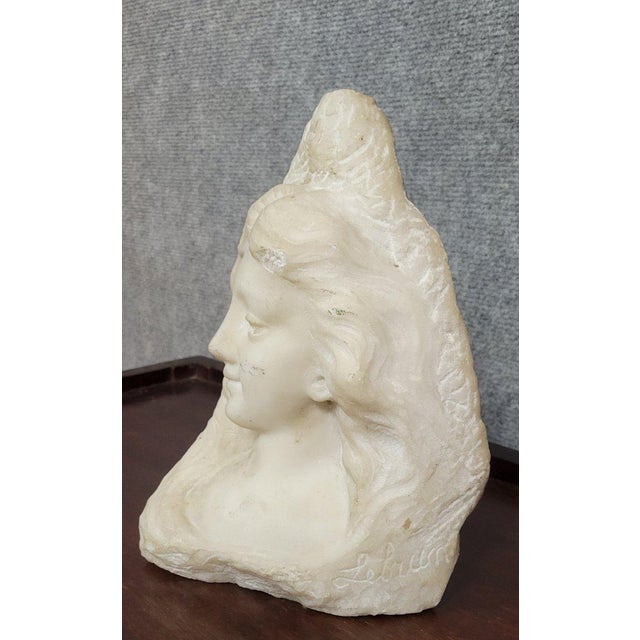 Marble sculpture – female bust – signed lebrun an elegant marble sculpture depicting a female face, rendered in a...
