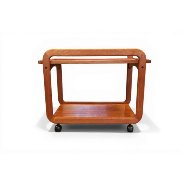 Danish teak serving trolley with timeless form and lovely function. The trolley has two levels and on top there is a...
