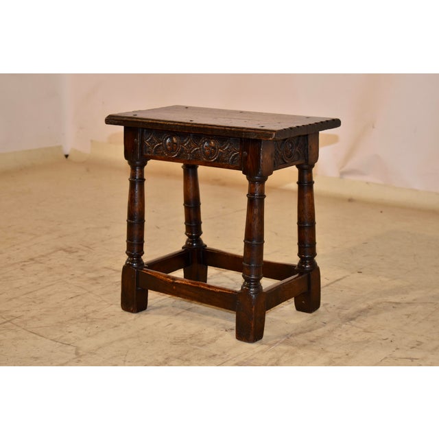 Early 19th century oak joint stool from England. The top has hand carved stacked beveled edges on the longer sides and pie...