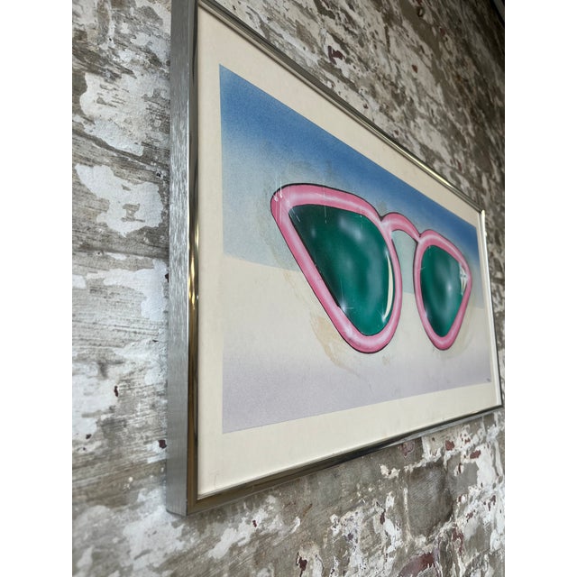Bold, beachy, and undeniably cool. This vintage pop art print features a pair of oversized cat-eye sunglasses in hot pink...
