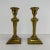 Pair of brass colored metal candlestick featuring ram head at the top of the stem.