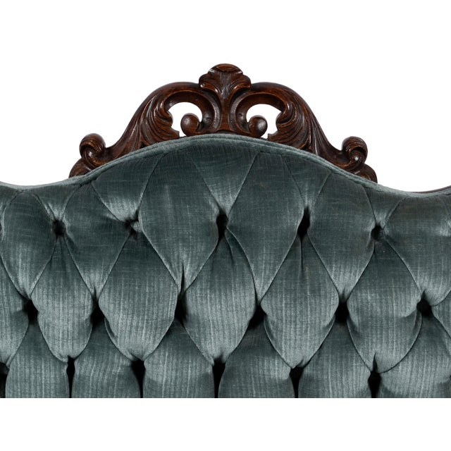 VICTORIAN COURTING SETTEE. New button tufted upholstery in an elegant gray velvet. American, 19th century. Carved...