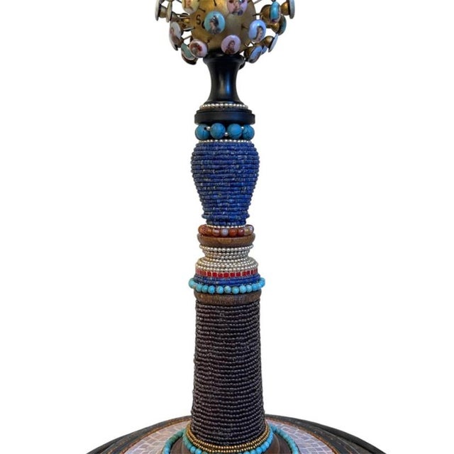 The work is entitled "the family" and is made up of an assemblage of heterogeneous materials, largely antique, chosen for...