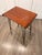 Made in Italy, 1960s. This side table features a varnished iron-and-brass frame, a multi-layered ebonized beech top, and a...