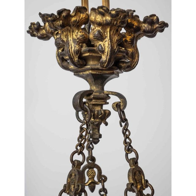 This neo-Gothic six-arm candle chandelier is a beautiful example of historical design. The chandelier is made of bronze...