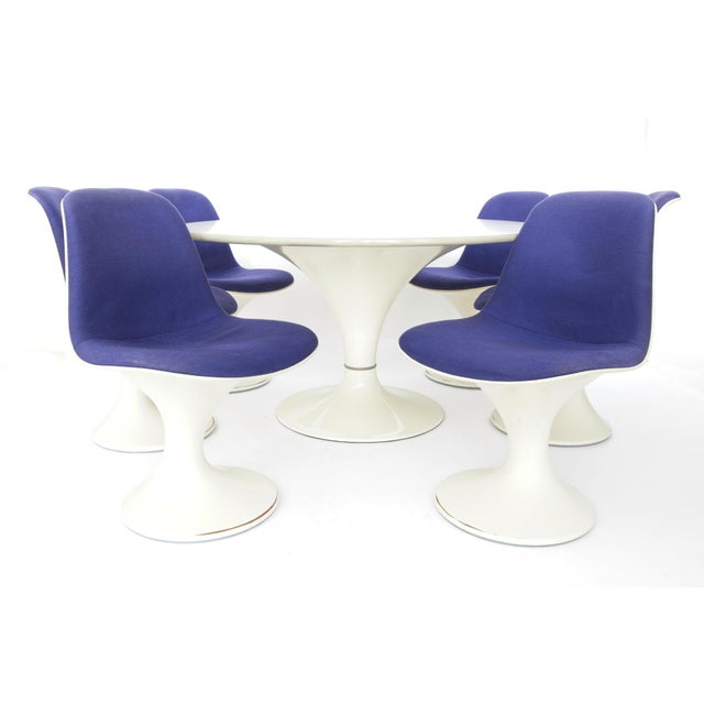 The set consists of six chairs with purple fabric covers and a matching dining table (diameter: 121 cm, height: 69.5 cm)....
