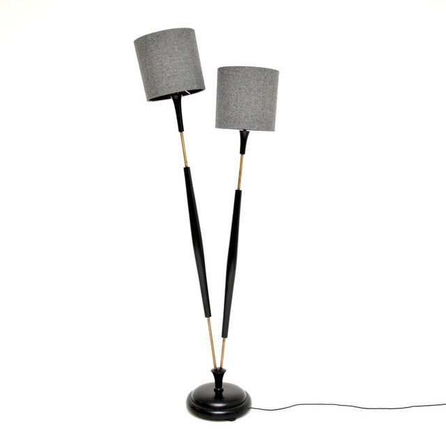 A very stylish and unusual vintage two headed floor lamp in ebonised wood and brass. This was made in England, it dates...