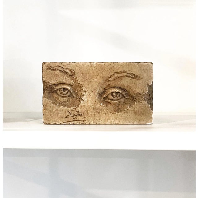 A vintage hand-carved lover's eyes sculpture, signed by the artist. Dimensions: 7" L x 1-1/2" D x 4" H. A striking piece...