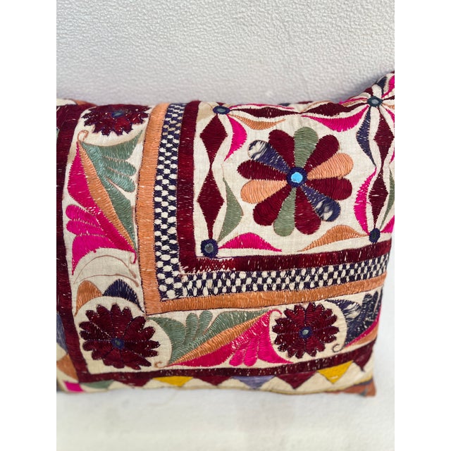 Elegant decorative pillow upholstered in a richly patterned Uzbek textile, featuring charming floral flowerhead motifs and...