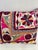Elegant decorative pillow upholstered in a richly patterned Uzbek textile, featuring charming floral flowerhead motifs and...