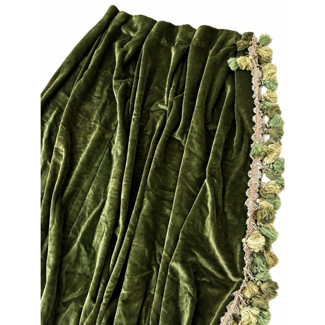 An elegant and luxurious drape crafted from sumptuous olive green velvet, beautifully finished with an ornate decorative...