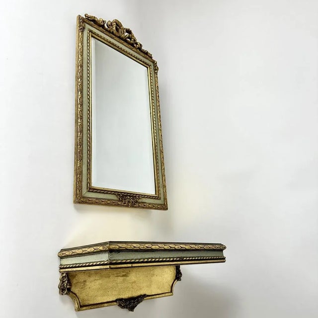 Very beautiful wall mirror in wooden carved frame with gold plated wooden console, Belgium, 1960s. Hand-carved gilt wooden...