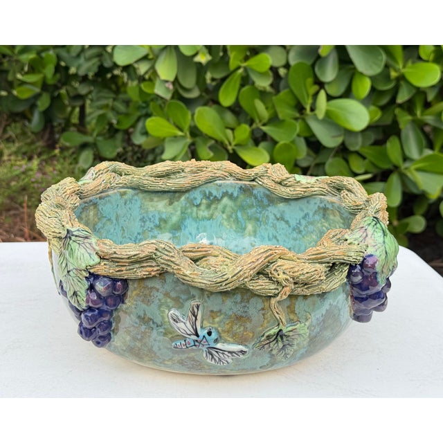 Vintage Mexican folk art ceramic bowl with an elaborate, heavily textured grapevine border. Several dimensional grape...
