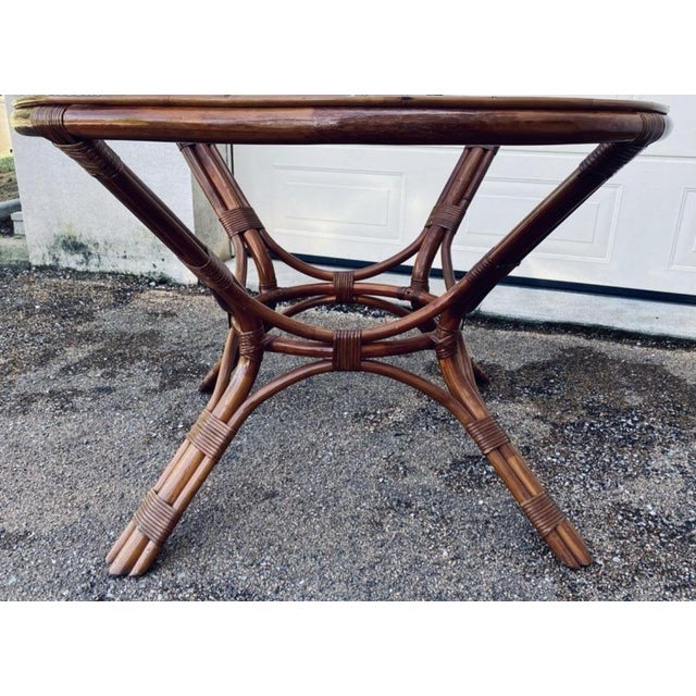 Pretty round rattan and wicker table with glass top Height 76cm Width 113cm Depth 113cm